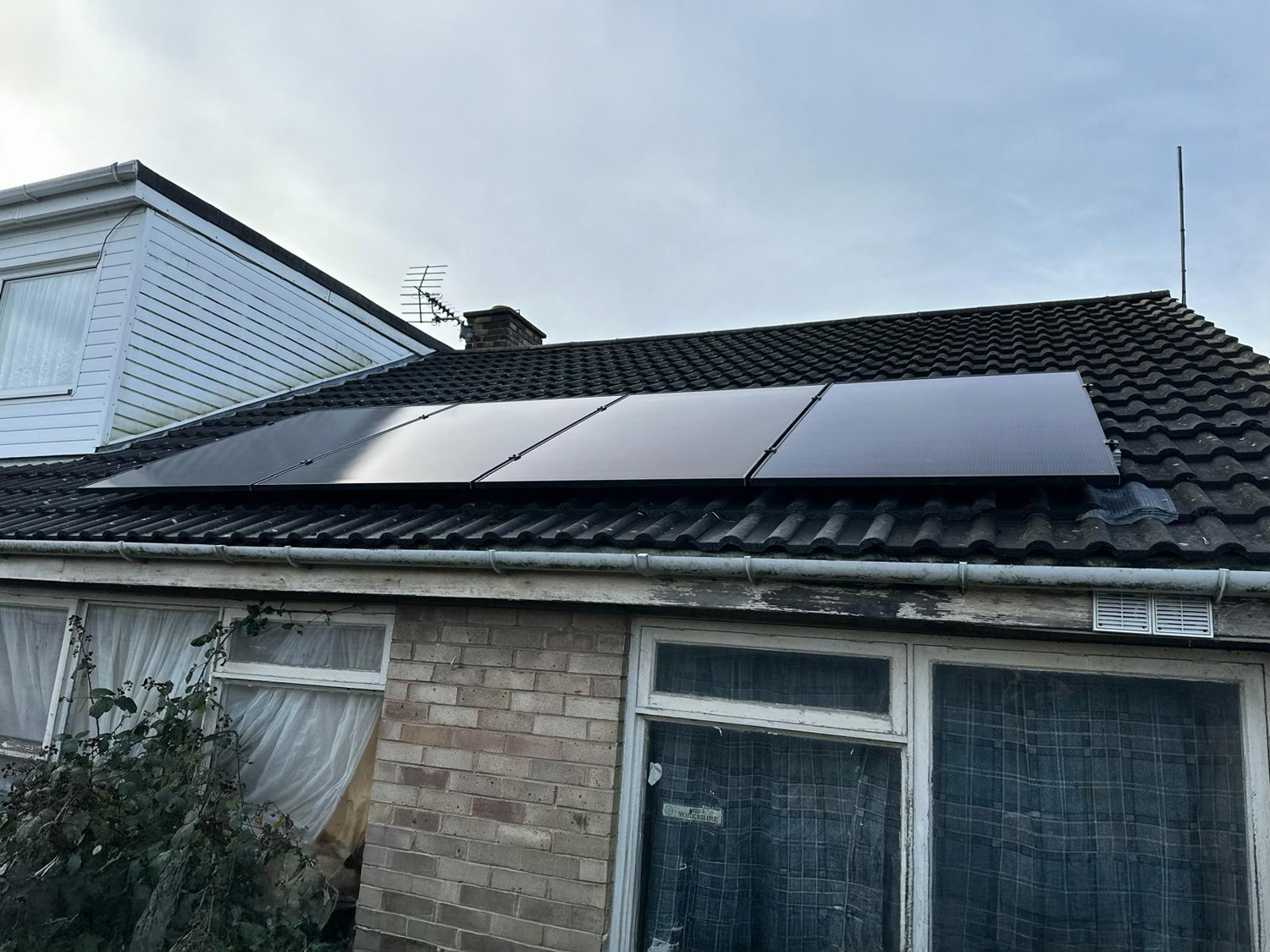 An image of solar panels on the roof of a house.