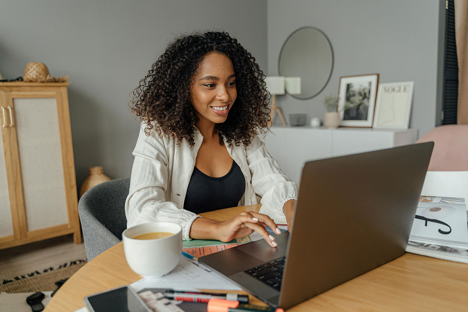 A woman working at a laptop.