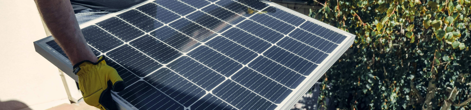 An image of guy installing solar panels.
