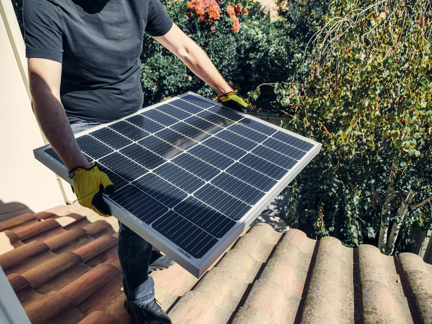 An image of guy installing solar panels.